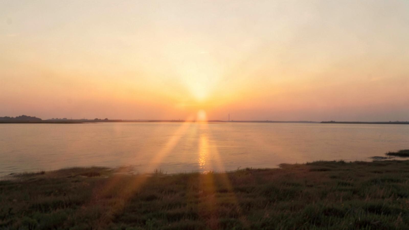 Warm sunrise over a calm horizon